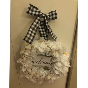 White flower wreath with welcome sign